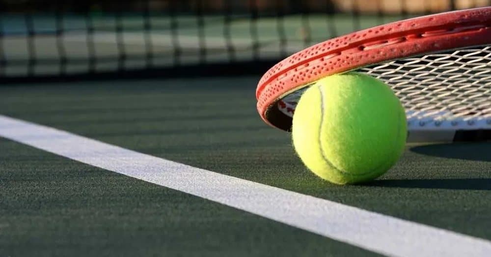 Tennis racket and ball on a court